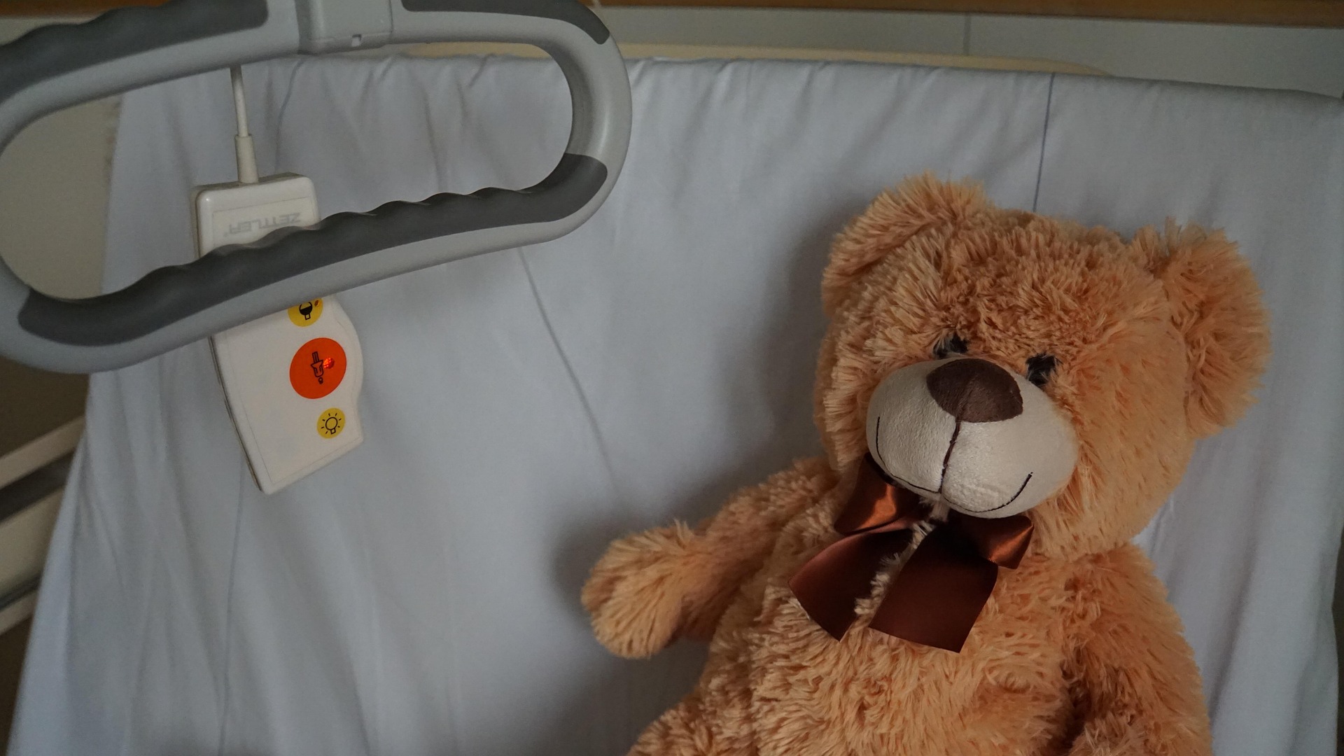 hospital bed with teddy bear