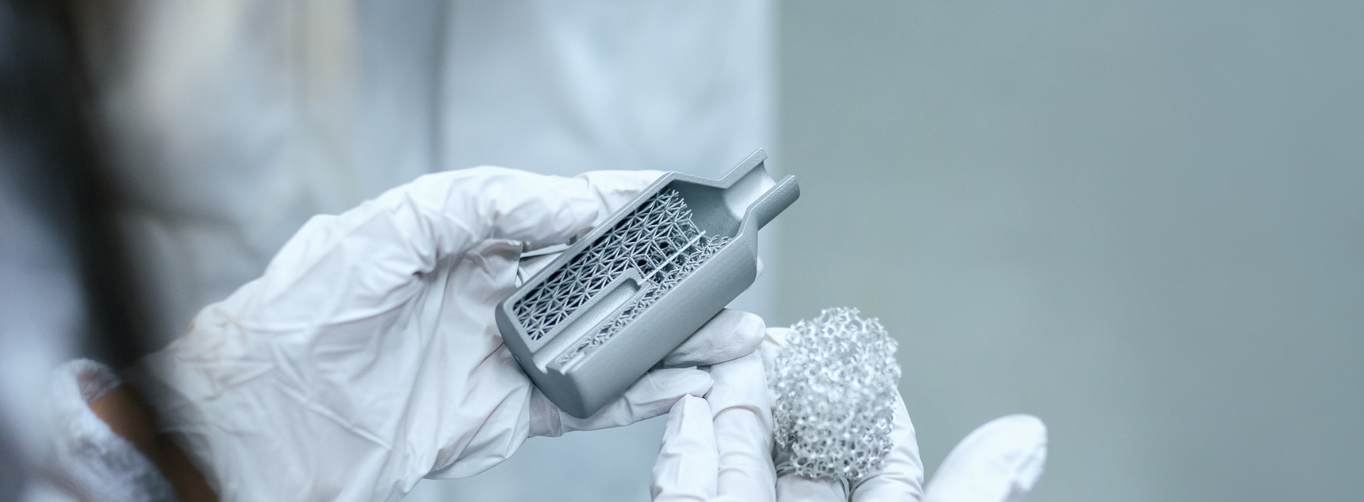 close-up of gloved hands holding metal device