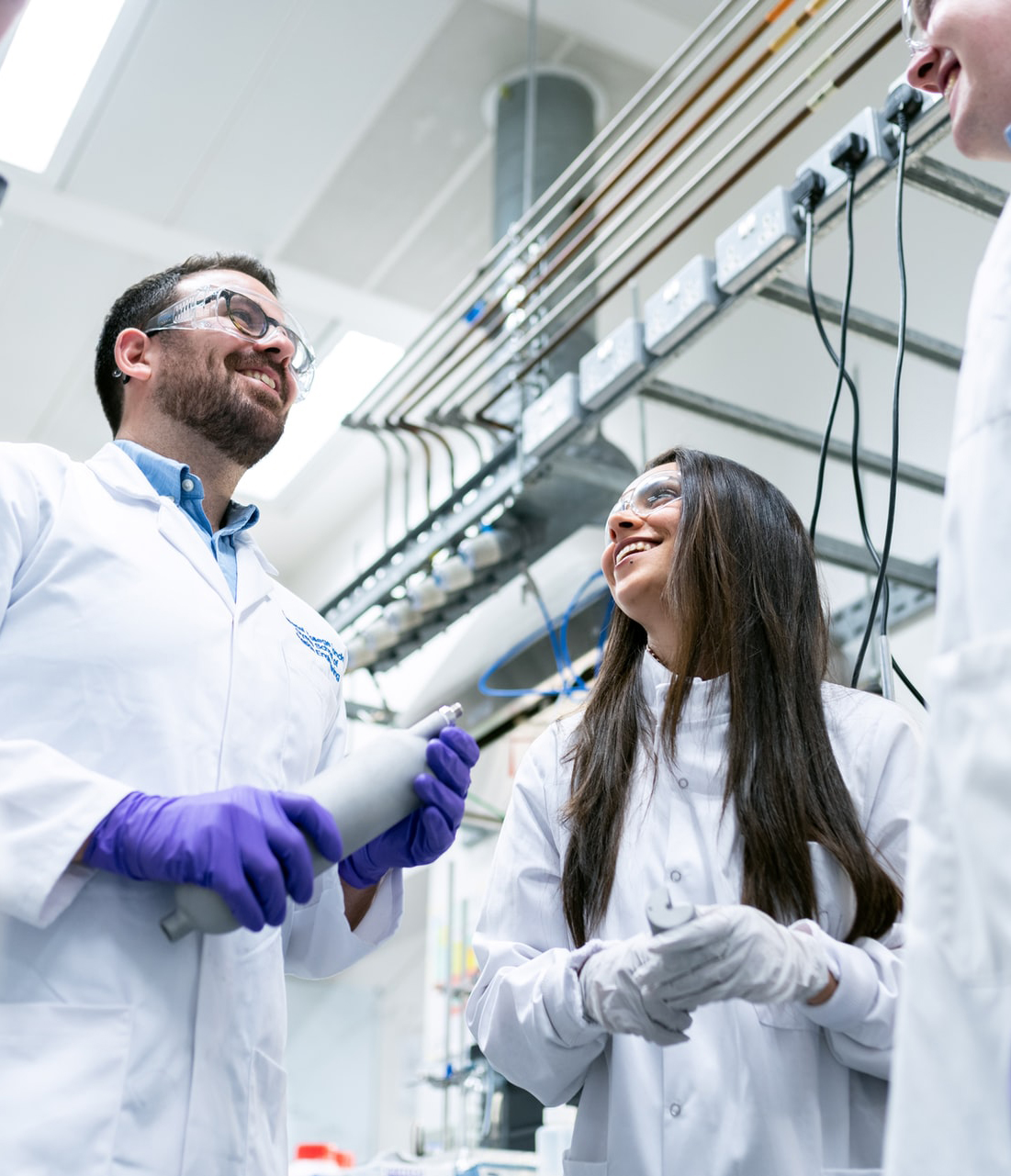 two researchers smiling in a lab